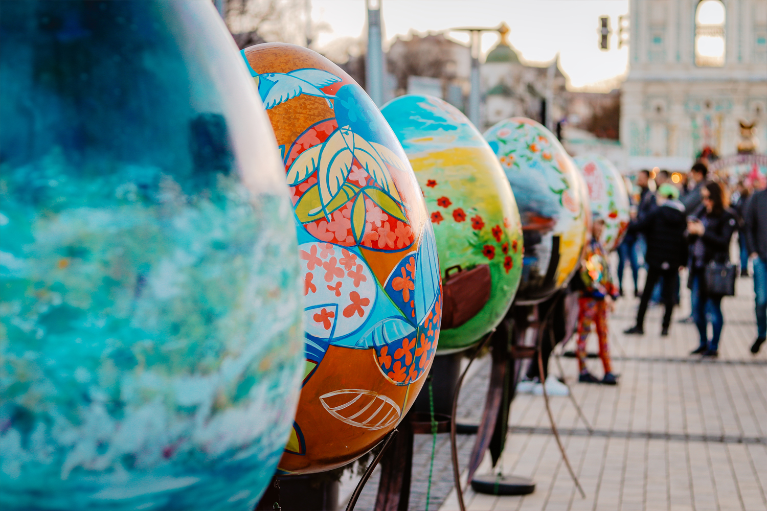 Painted egg sculptures displayed in a public square