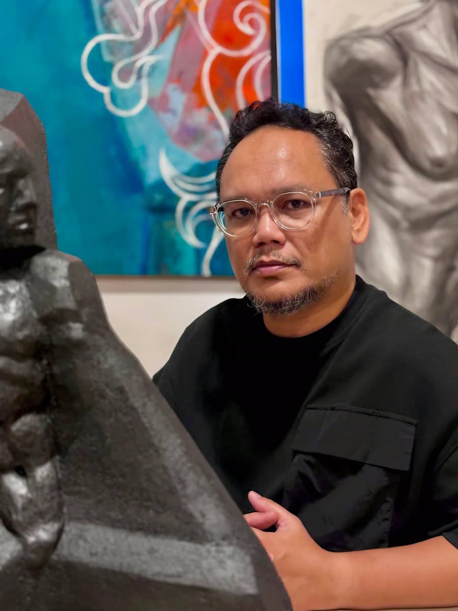Portrait of Rofi beside a sculpture